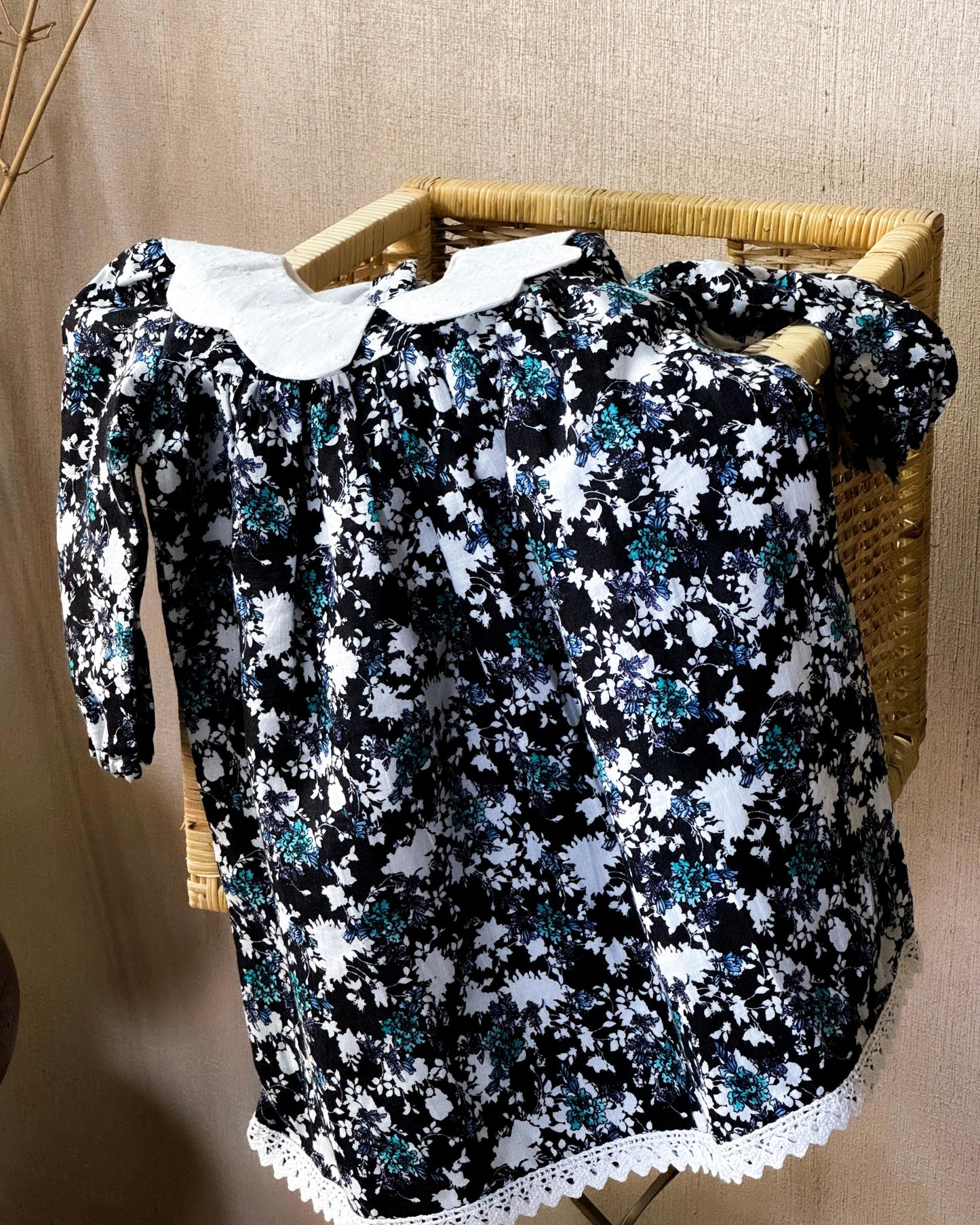 Vintage floral black cotton dress for girls with white Peter Pan collar and lace-trimmed hem, perfect for special occasions and everyday wear.