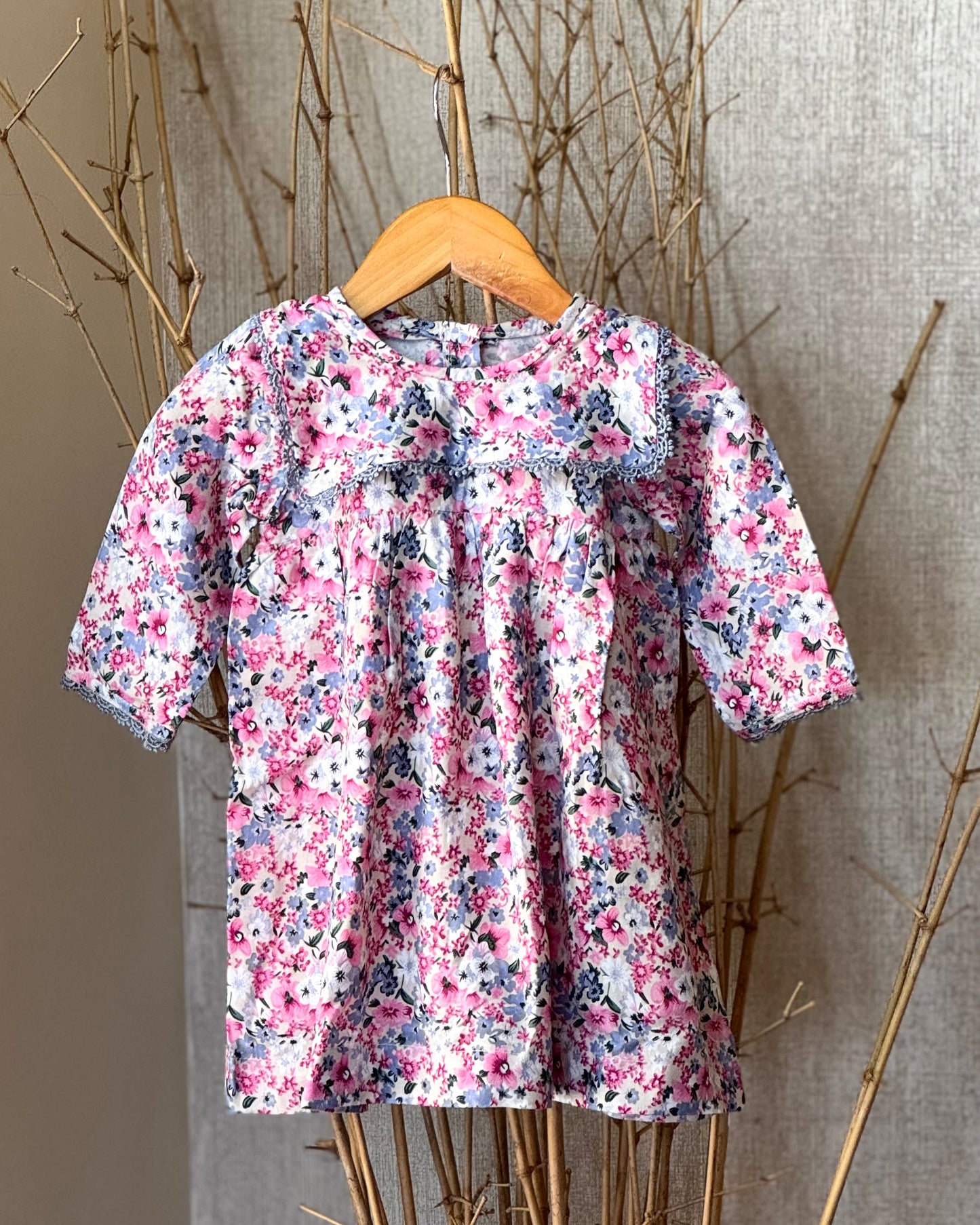 Floral cotton long-sleeve frock for girls with lace detailing, square yoke, and a pink-blue floral print—soft, breathable, and perfect for any occasion.