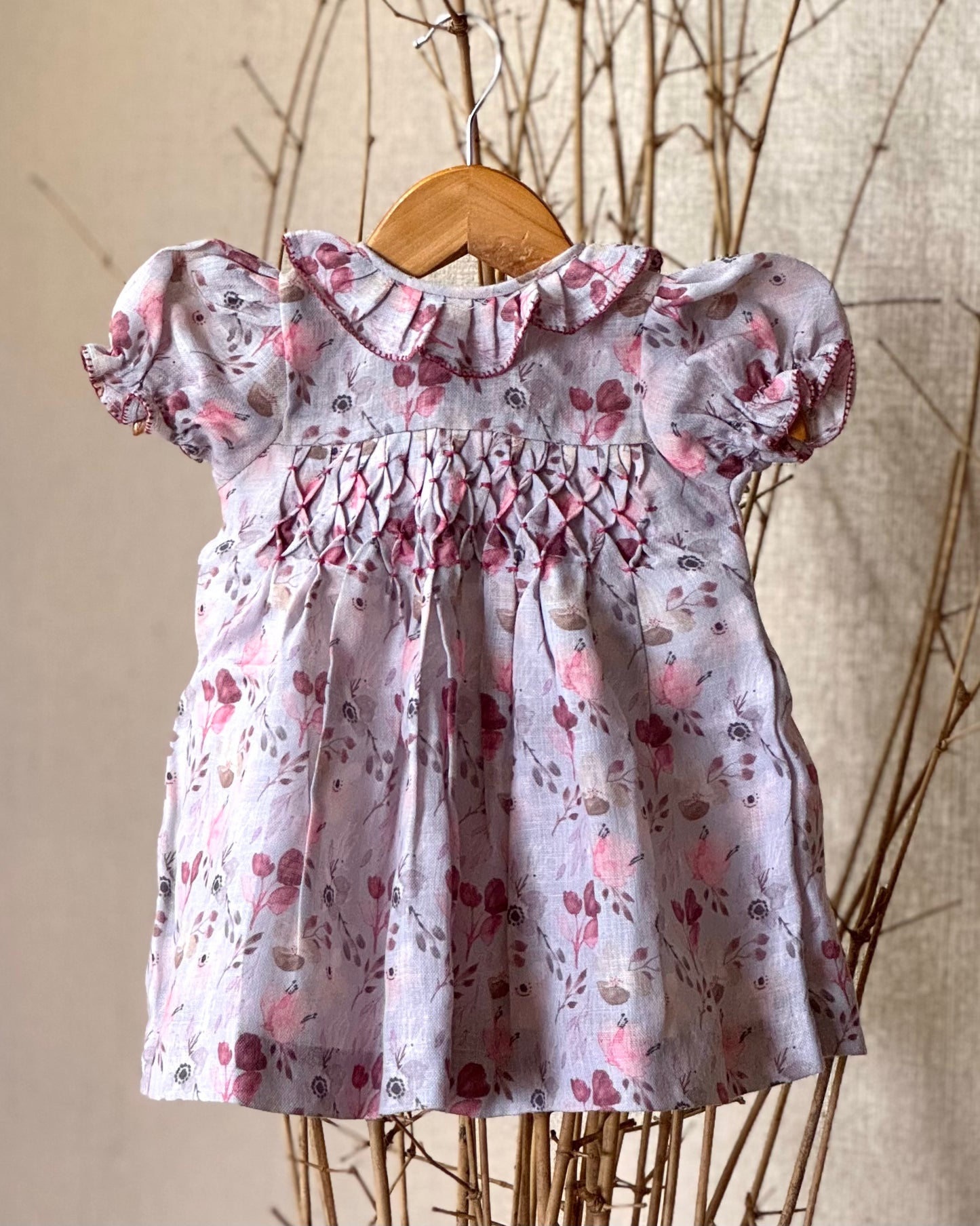 Lilac floral cotton linen smocked dress for girls with a ruffled collar, puffed sleeves, and a delicate vintage-style floral print—perfect for special occasions and everyday charm.