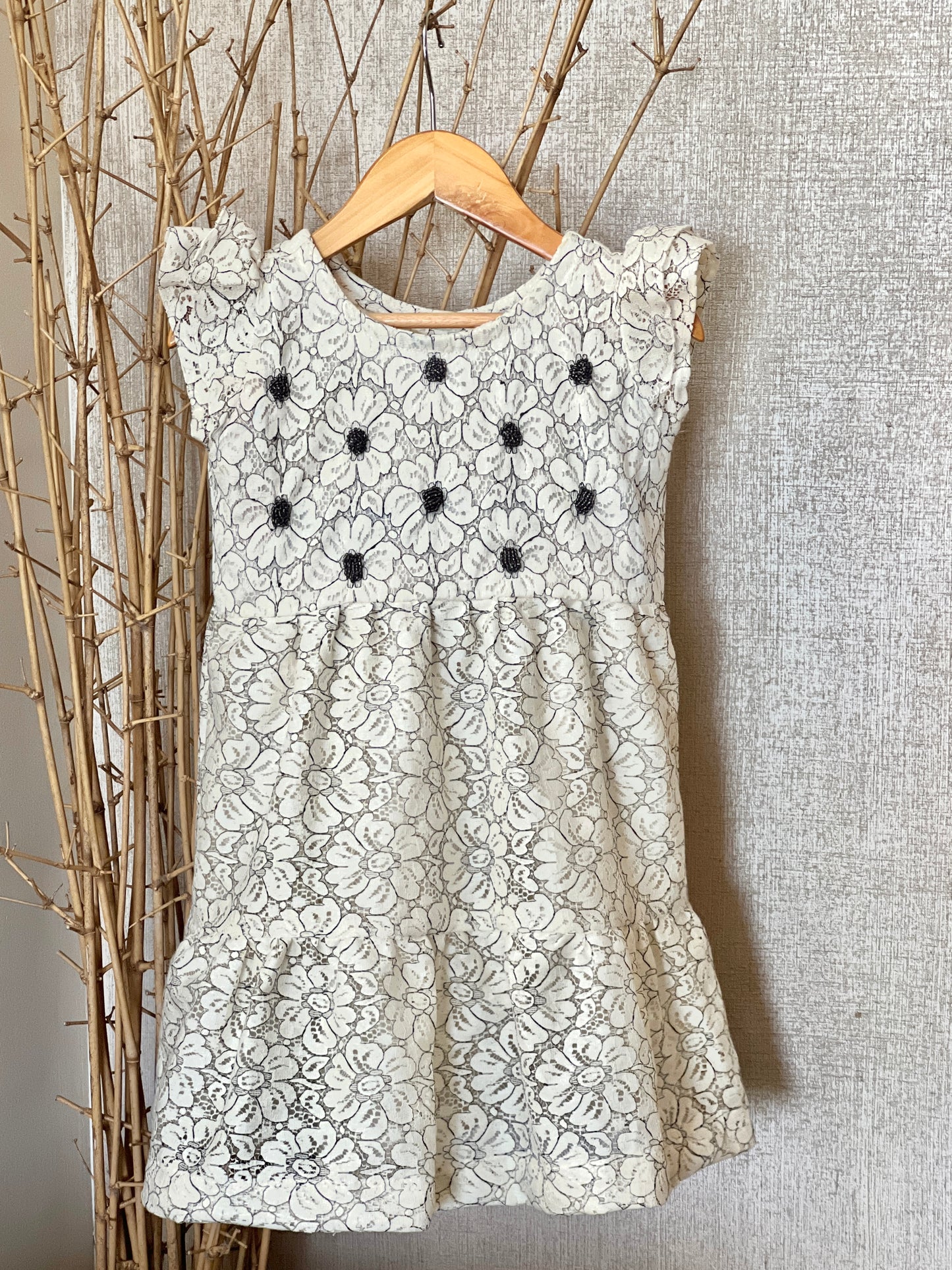 This Girls’ Lace Floral Dress features a delicate floral lace pattern with hand-beaded flower centers, a flattering flared hemline, and a chic vintage look—perfect for special occasions, birthdays, or celebrations!
